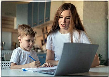 child with his mother in front of his computer