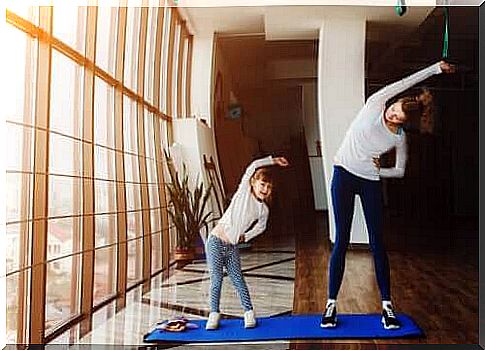 mother and daughter doing sports at home