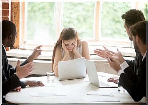 A stressed woman in a meeting.