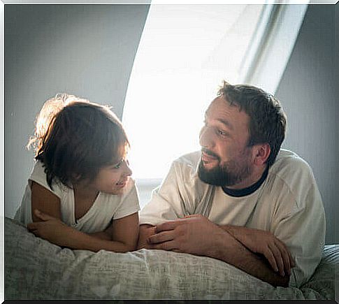 A father and his son talking in the dark light.