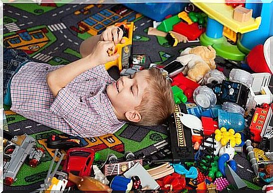 Child in his room with a lot of toys