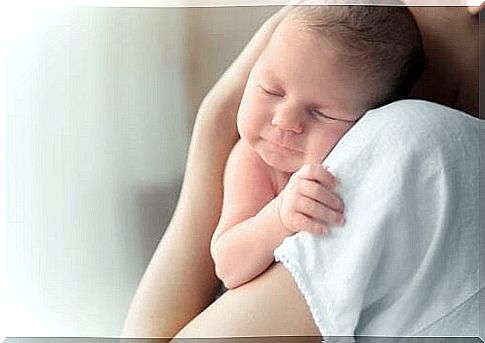 A baby sleeps in his mother's arms