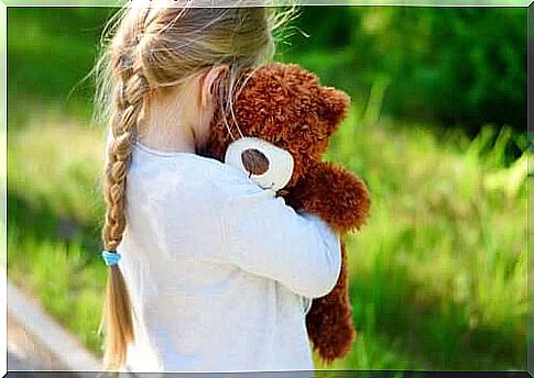 A girl holding her teddy bear