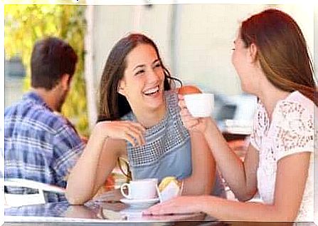 A mother and her daughter drinking coffee.