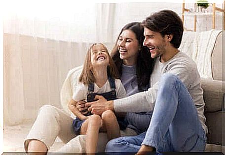 Parents playing with their daughter.