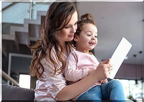 A little girl watching a book-trailer