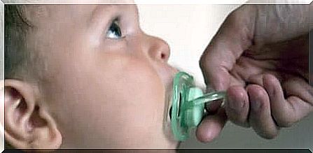 Take the pacifier from a child.