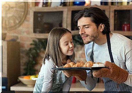 A father and his daughter who smell like cakes coming out of the oven. 