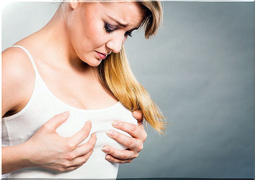 Woman suffering from breast engorgement. 