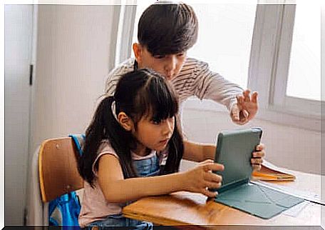 two children looking at a tablet